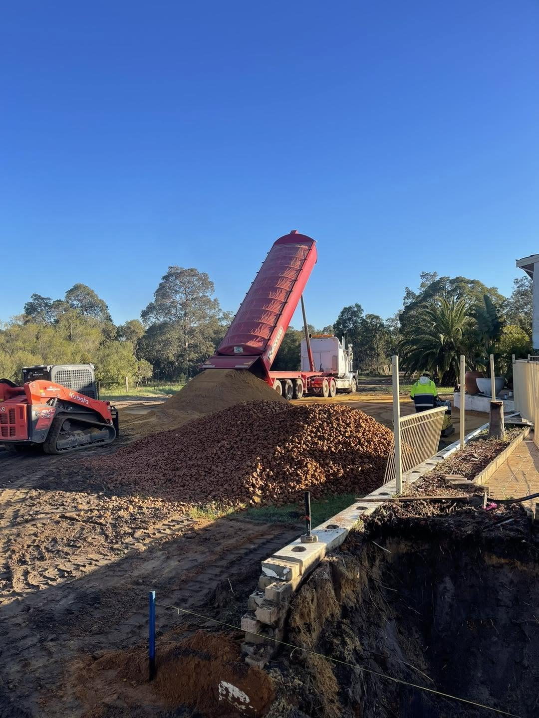 Conveyor truck spreading gravel supplied and delivered by Gidge Civil