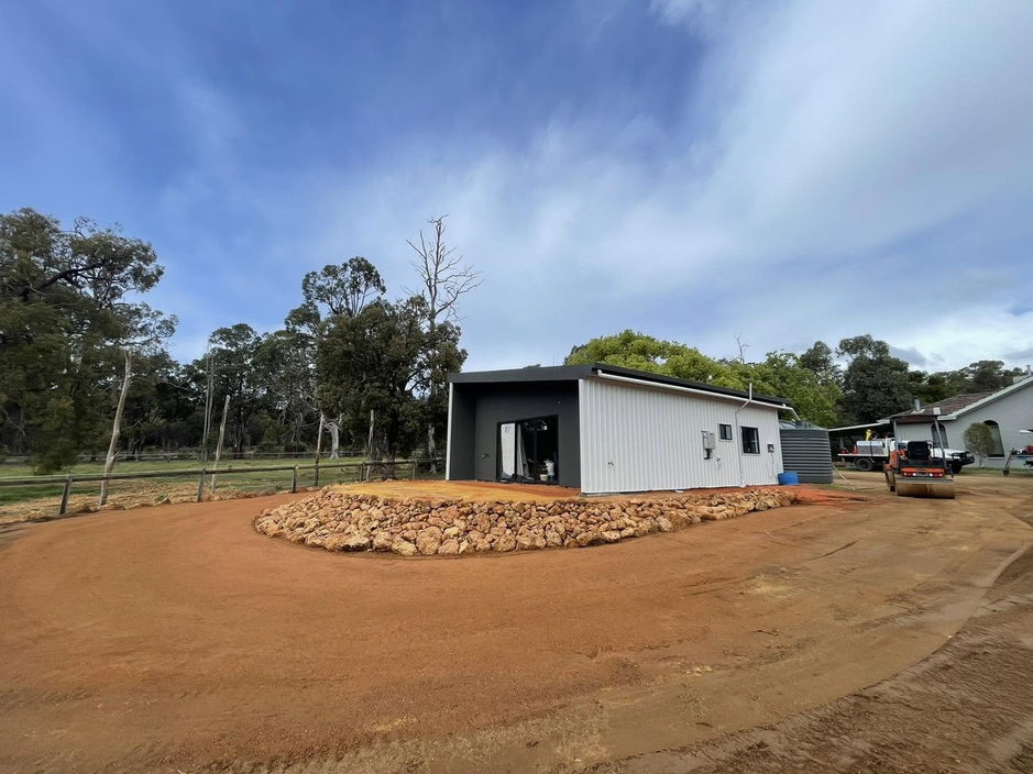 Finished shed pad with rock feature garden on a Perth Hills property